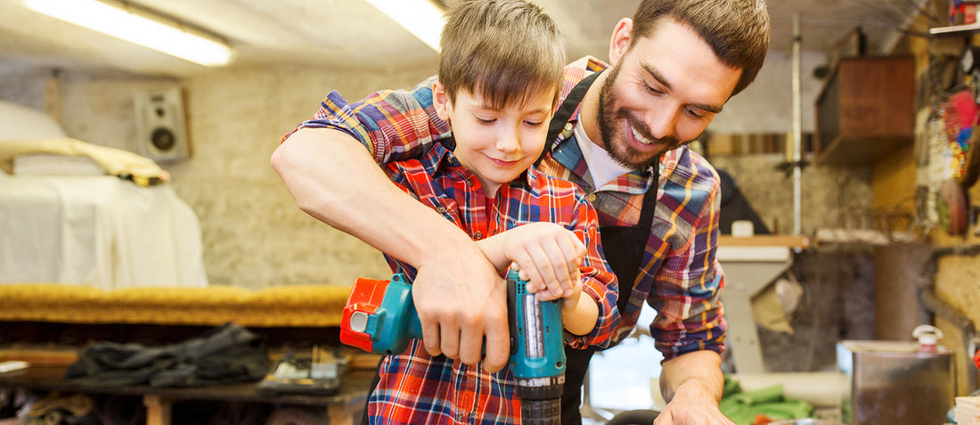 Father and son in matching plaid working on a wood project together